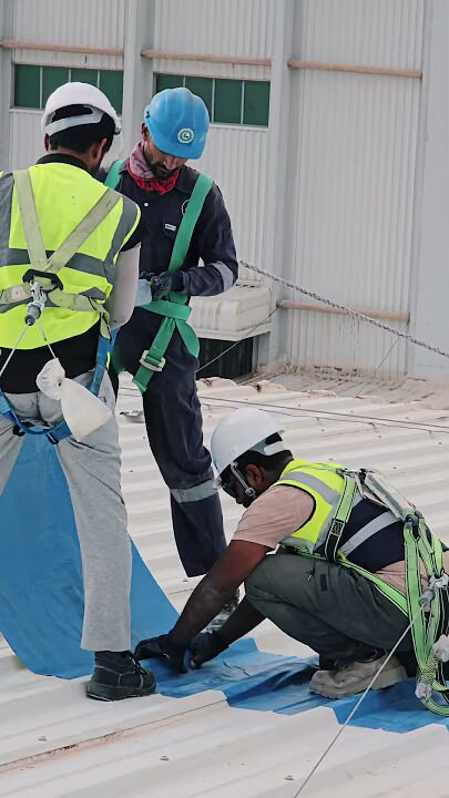 Roof work carried out with fall protection in place